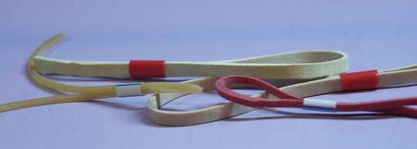 Different size rubber bands used to hold guides in place for wrapping